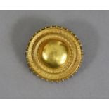 A late Victorian or Edwardian 15ct. gold Estruscan-revival circular shield brooch, 1¼” diam.;