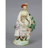 An 18th century Derby porcelain standing figure of a shepherdess with lamp, floral bocage, & on
