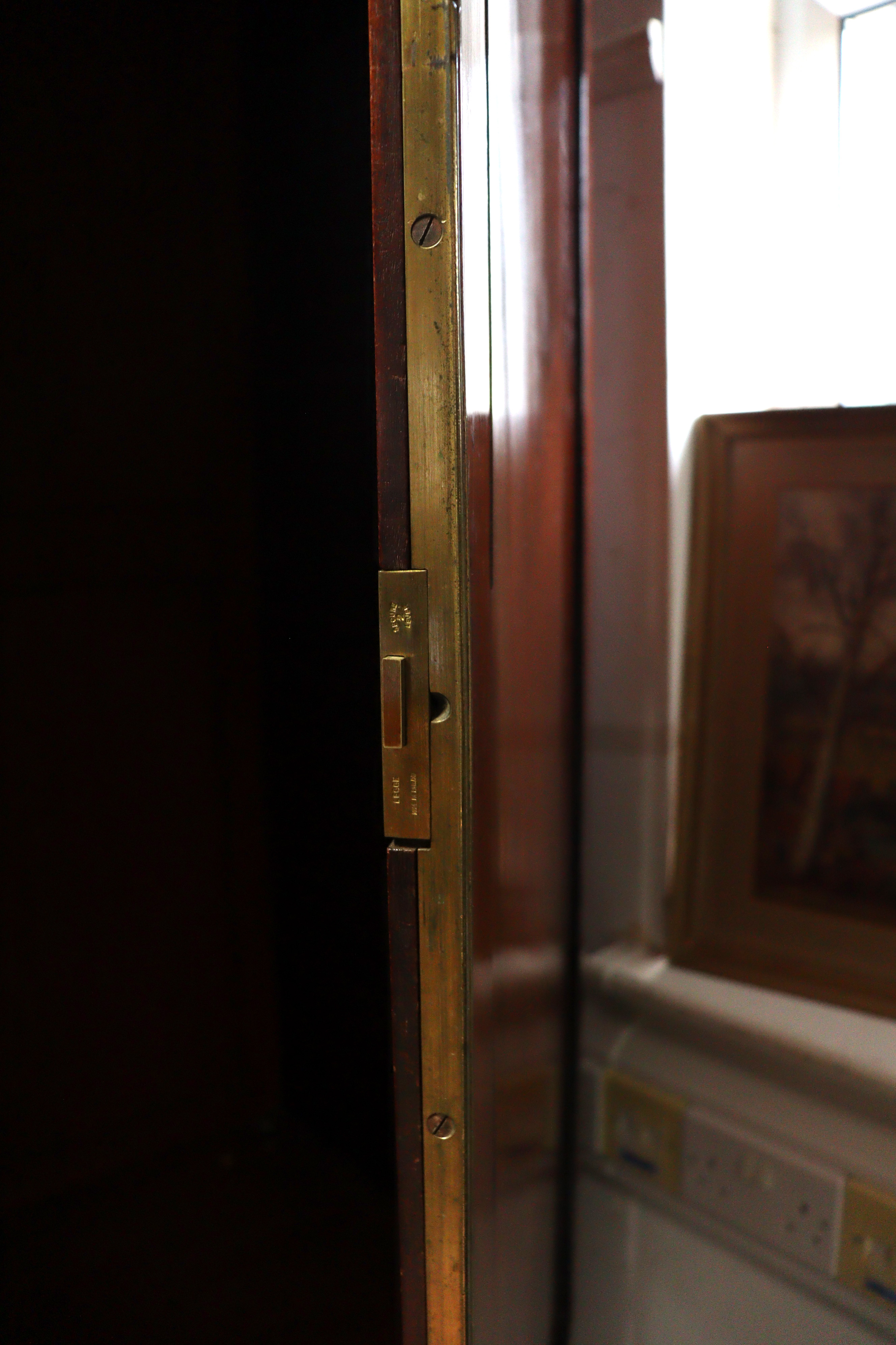 A 19th century inlaid mahogany wardrobe with a hanging compartment enclosed by pair of panel - Image 7 of 7