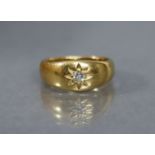 An Edwardian heavy 18ct. gold gent’s ring, gypsy-set with a small diamond; size: S; weight: 14.7gm.