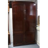 A 19th century inlaid mahogany wardrobe with a hanging compartment enclosed by pair of panel