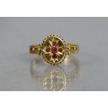 An antique gold ring with oval panel set five small rubies in the form of a cross; size: O;