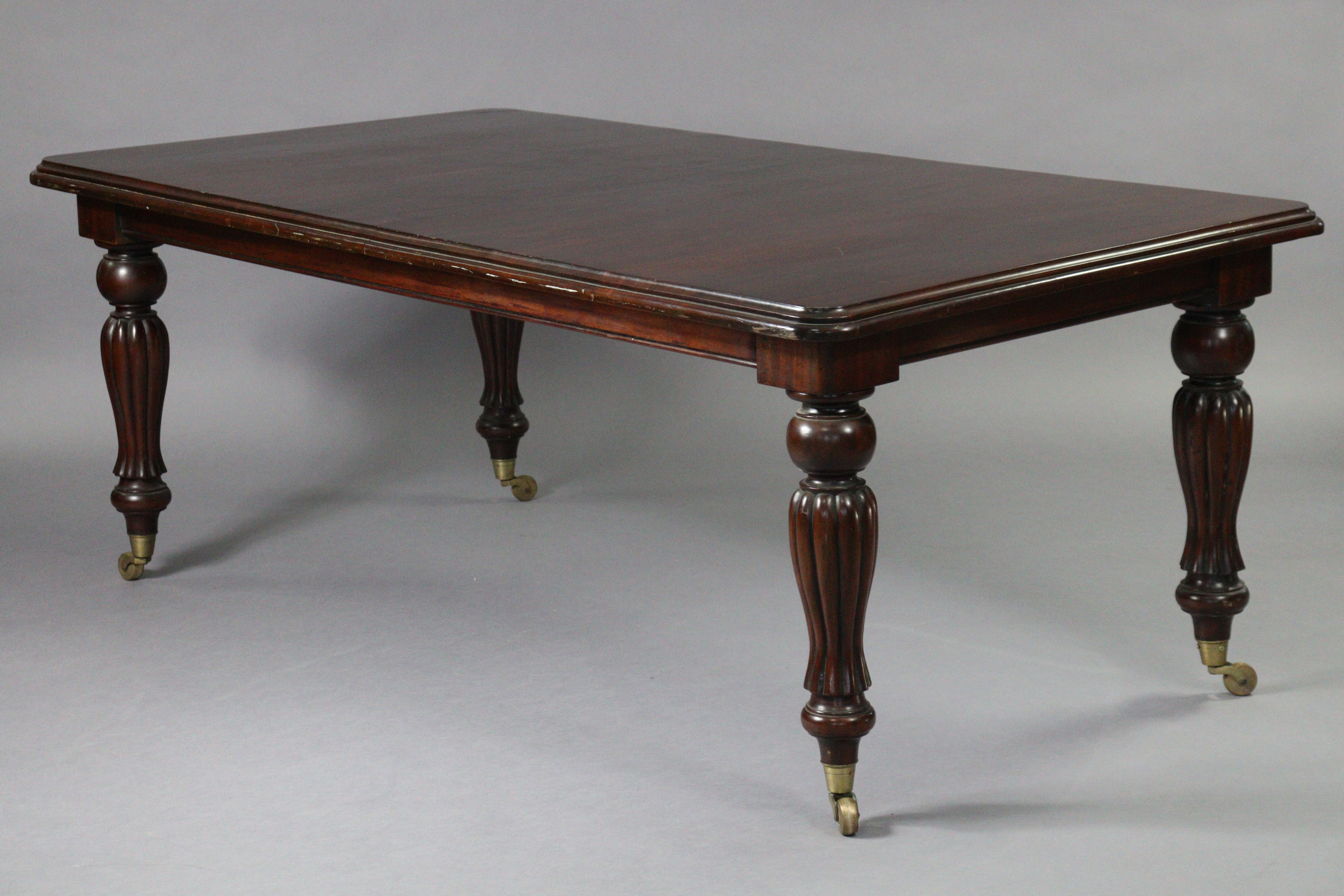 A Victorian-style mahogany dining table, with moulded edge & rounded corners to the plain