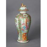 A 19th century Cantonese porcelain slender baluster vase & cover painted with figures, flowers, &