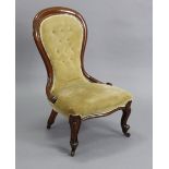 A Victorian mahogany-frame spoon-back nursing chair, upholstered yellow velour, on carved cabriole