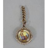 A Victorian gold & later enamel-decorated half-sovereign dated 1887, mounted behind glass as pendant