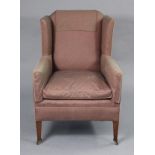 A late Victorian wing-back armchair, upholstered mauve silk fabric, on square tapered mahogany