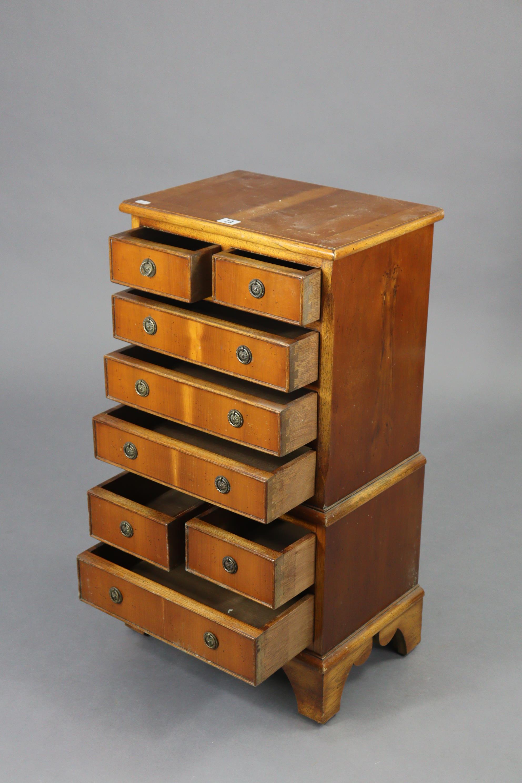 A reproduction yew wood small chest-on-chest fitted with an arrangement of four short & four long - Image 2 of 4