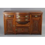 A late Victorian carved mahogany break-front sideboard fitted two long drawers to centre above
