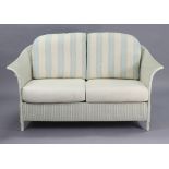 A modern white Lloyd Loom three-piece lounge suite comprising a two-seater settee, 60” long, & a