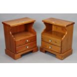 A pair of pine bedside cabinets, each with an open recess above two long drawers, & on a shaped