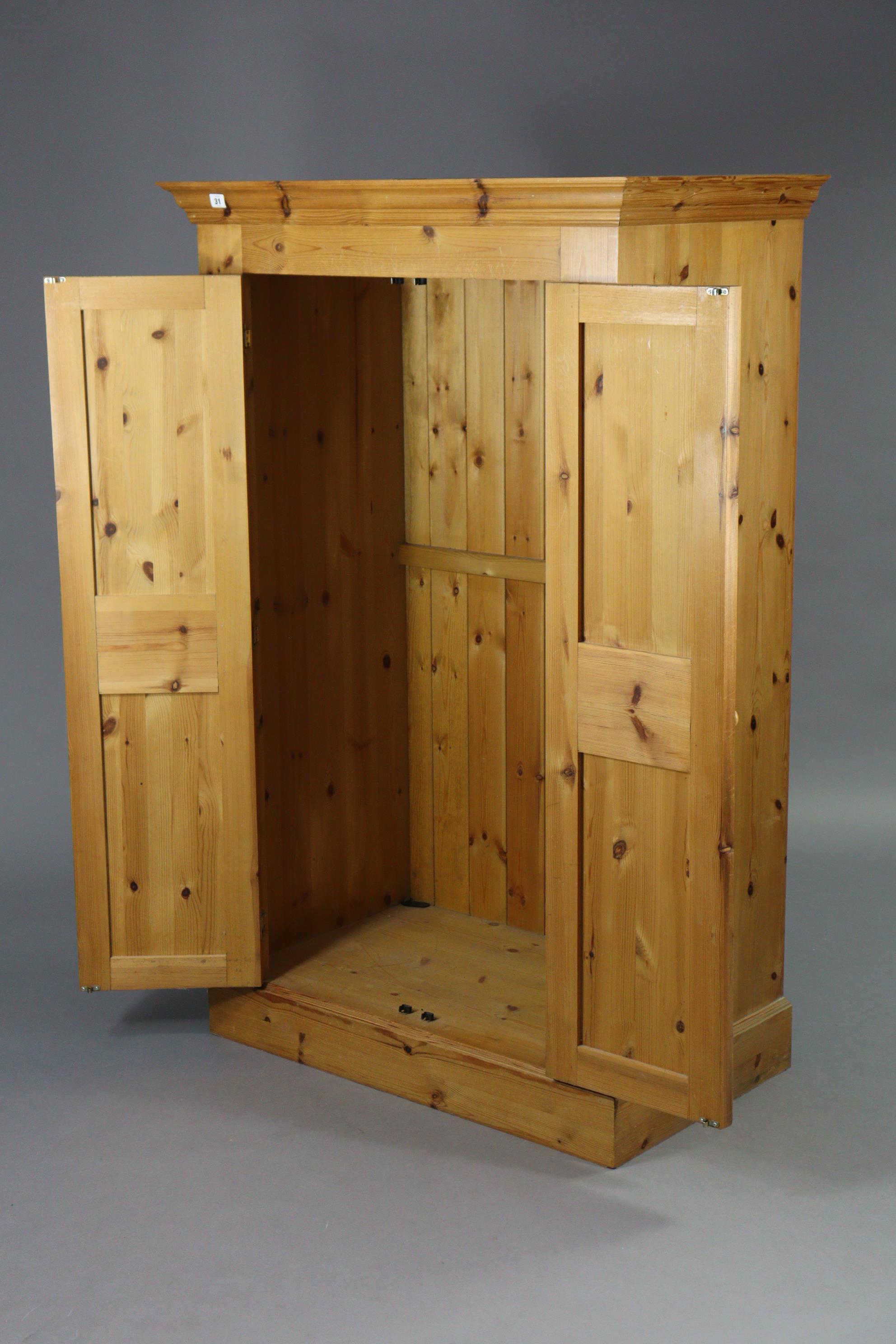 A pine nursery wardrobe enclosed by a pair of fielded panel doors, & on a plinth base, 38” wide x - Image 2 of 2