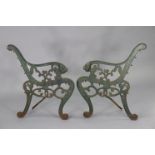 A pair of green painted cast-iron garden-bench supports, 29” high.