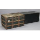 A black painted deal travelling trunk with a hinged lift-lid & with iron side handles, 38” wide; & a