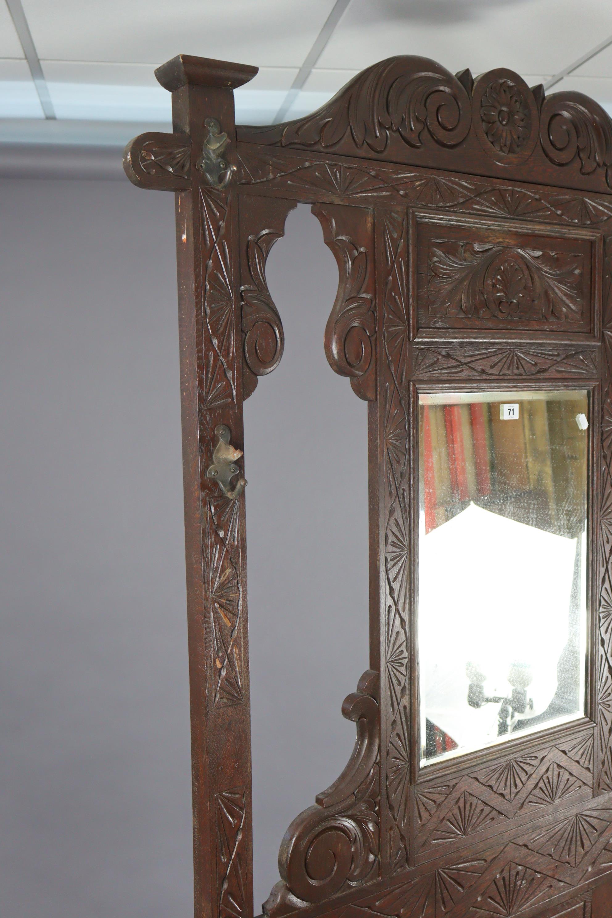 A 1930’s carved oak hall stand inset bevelled rectangular mirror to top, with a hinged box seat & - Image 5 of 7