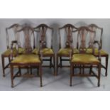 A set of six Hepplewhite-style mahogany dining chairs (including a pair of carvers), each with a