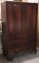 An early 19th century mahogany linen press (for restoration) the upper part enclosed by a pair of