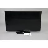 A Panasonic 50” LCD television with a remote control.