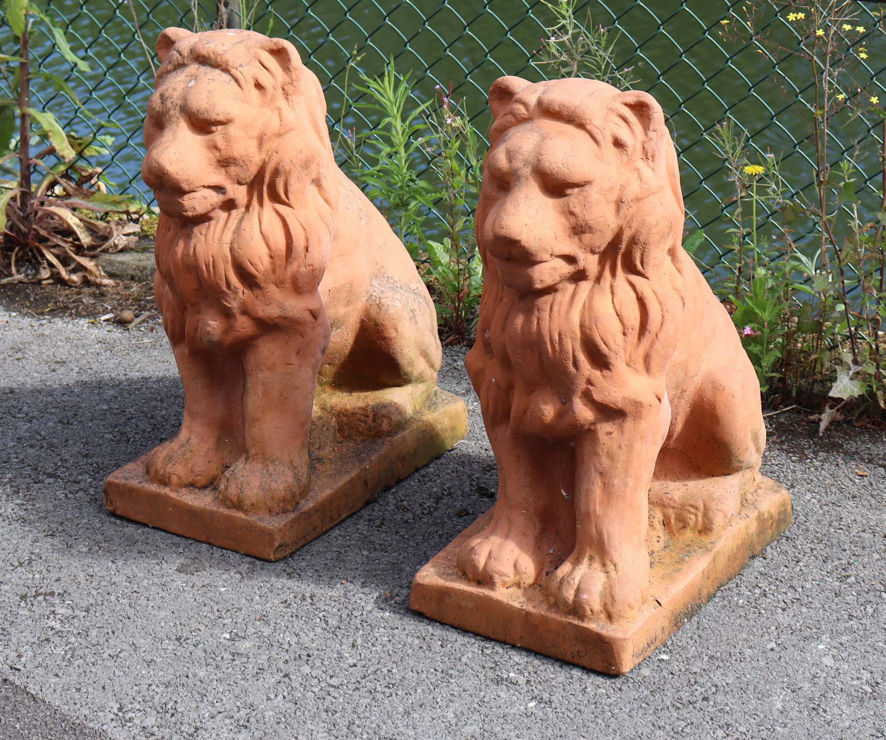 A pair of moulded terracotta garden statues in the form of seated lions, each on rectangular - Image 2 of 6