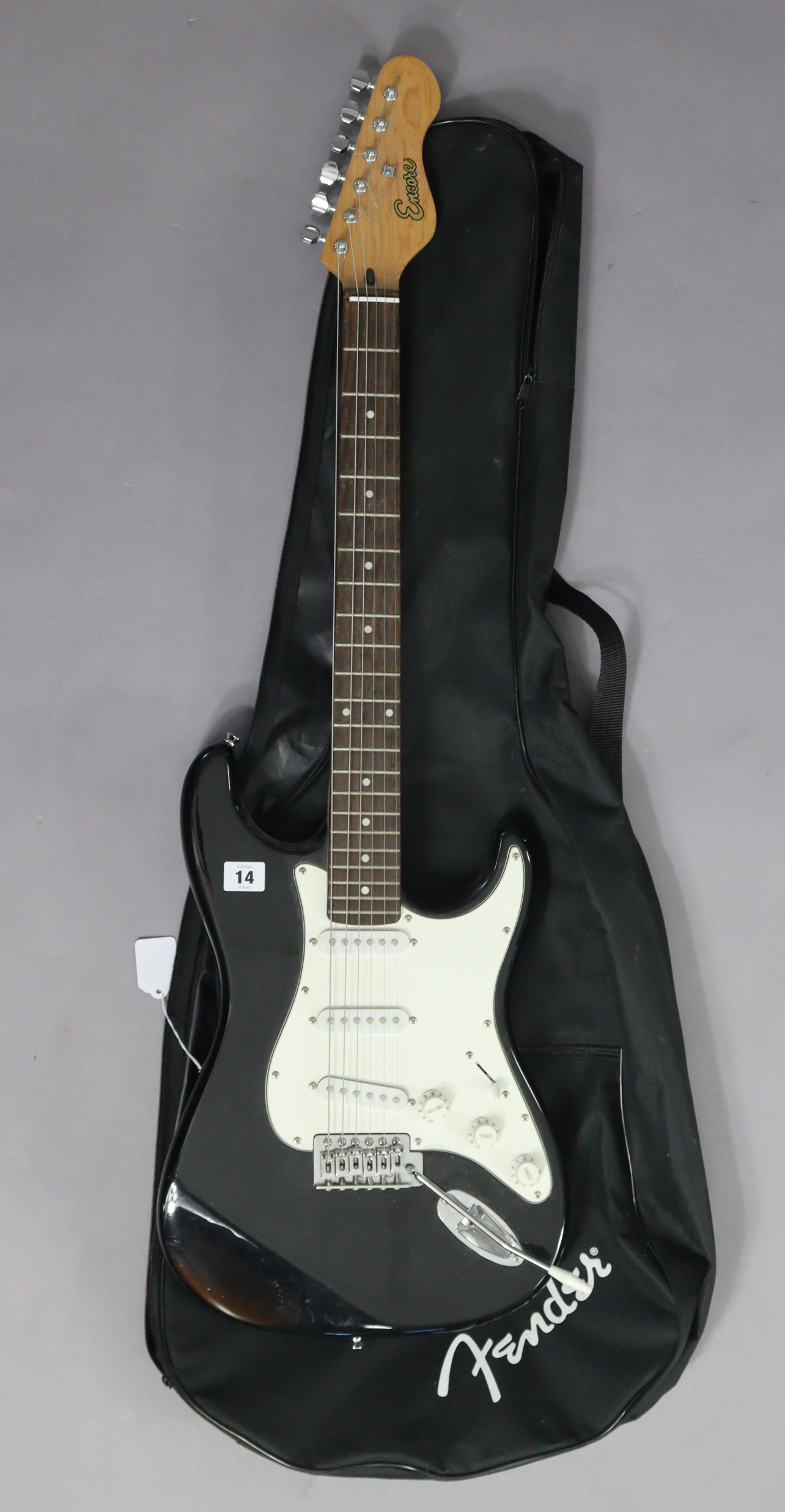 An Encore six-string electric guitar with case.