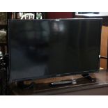 A Sharp 40” LCD television with a remote control.