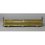 A regency brass fender with a pierced frieze, & on lion-paw feet, 42½” long.