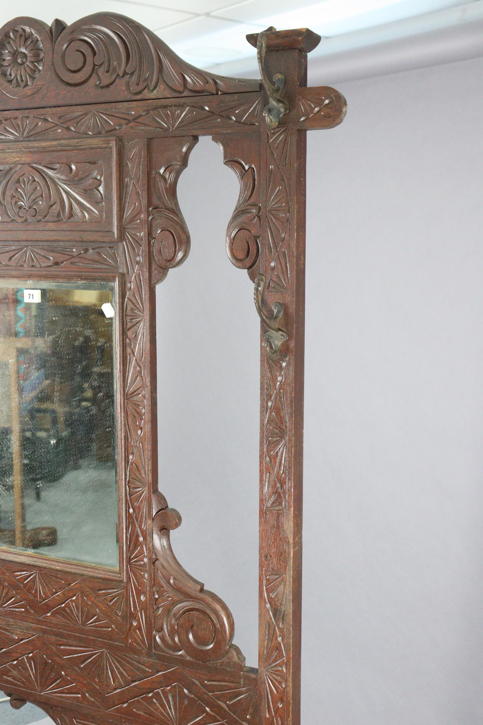 A 1930’s carved oak hall stand inset bevelled rectangular mirror to top, with a hinged box seat & - Image 6 of 7