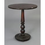 A Victorian mahogany pedestal table with a circular top, & on a vase-turned centre column & a