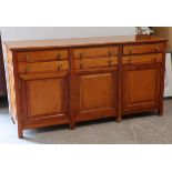 A Multiyork cherry wood sideboard fitted three ranks of two long drawers above cupboards enclosed by