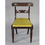 A regency mahogany bow-back dining chair with carved decoration & padded drop-in seat, & an elbow