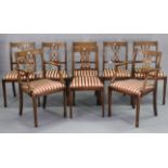 A set of eight reproduction mahogany splat-back dining chairs (including a pair of carvers), each