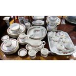 A Royal Worcester bone china “Holly Ribbons” extensive eight-one piece dinner, tea, & coffee