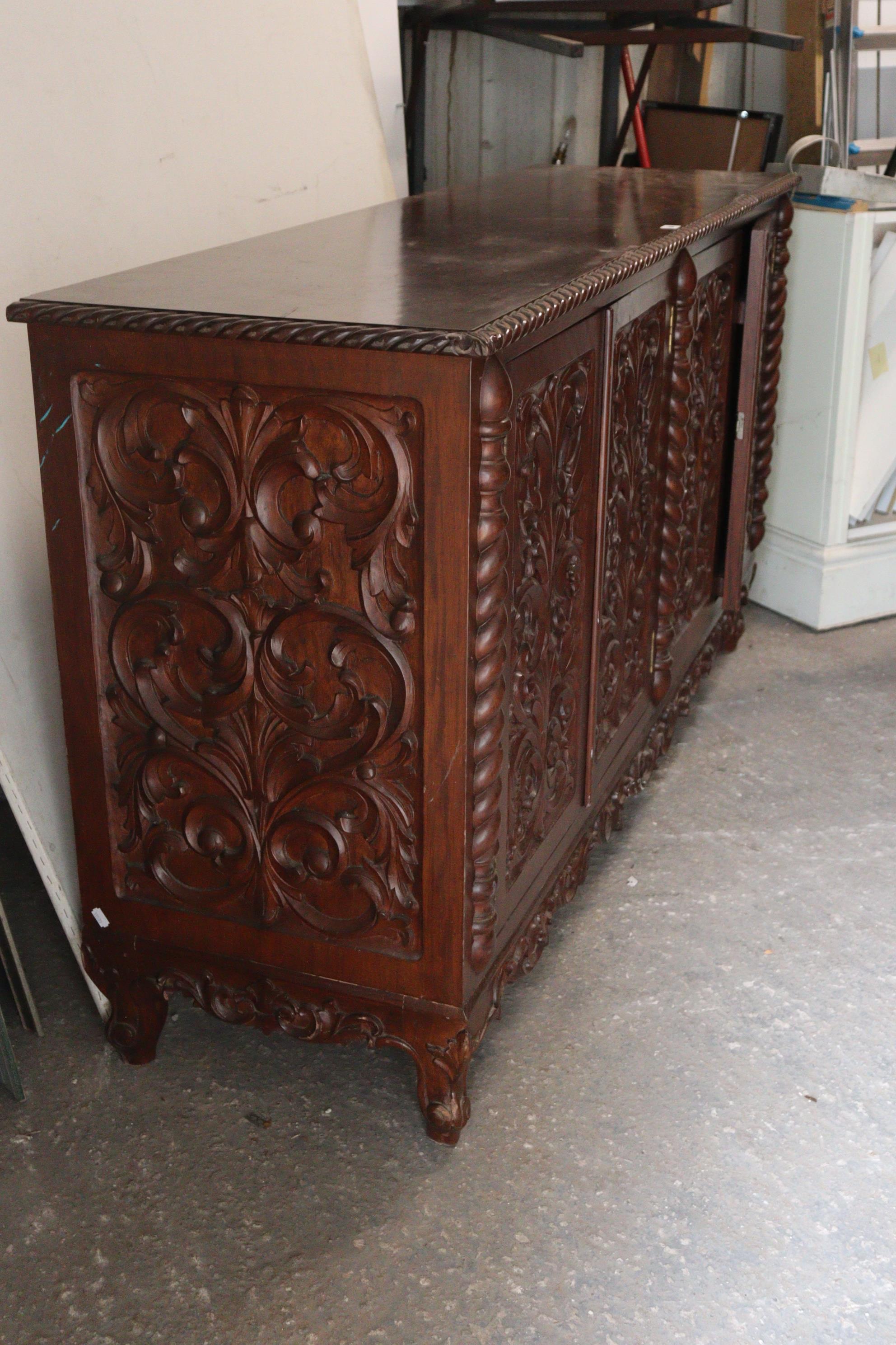 A mahogany sideboard with a gadrooned edge, enclosed by two pairs of carved panel doors, with a - Image 6 of 8