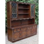A Jaycee oak tall wall cabinet the upper part with open shelves to centre flanked by a leaded glazed