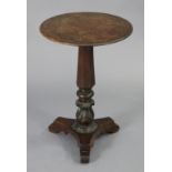 A Victorian mahogany pedestal table, with moulded edge to the circular fixed top, on tapered