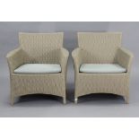 A pair of Skagerak of Denmark simulated rattan conservatory armchairs, each with a loose cushion to