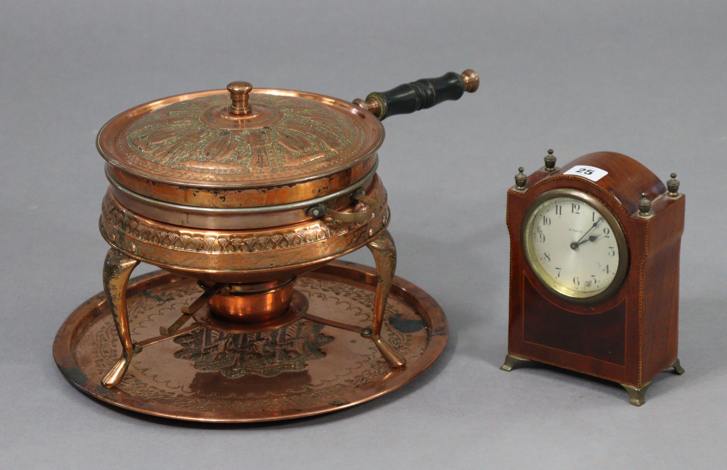 An Edwardian 8-day mantel clock in an inlaid-mahogany case, 7½” high; & a copper embossed cooking