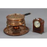 An Edwardian 8-day mantel clock in an inlaid-mahogany case, 7½” high; & a copper embossed cooking