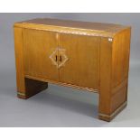 An oak art deco-style sideboard with a fitted interior enclosed by a pair of panel doors, & on