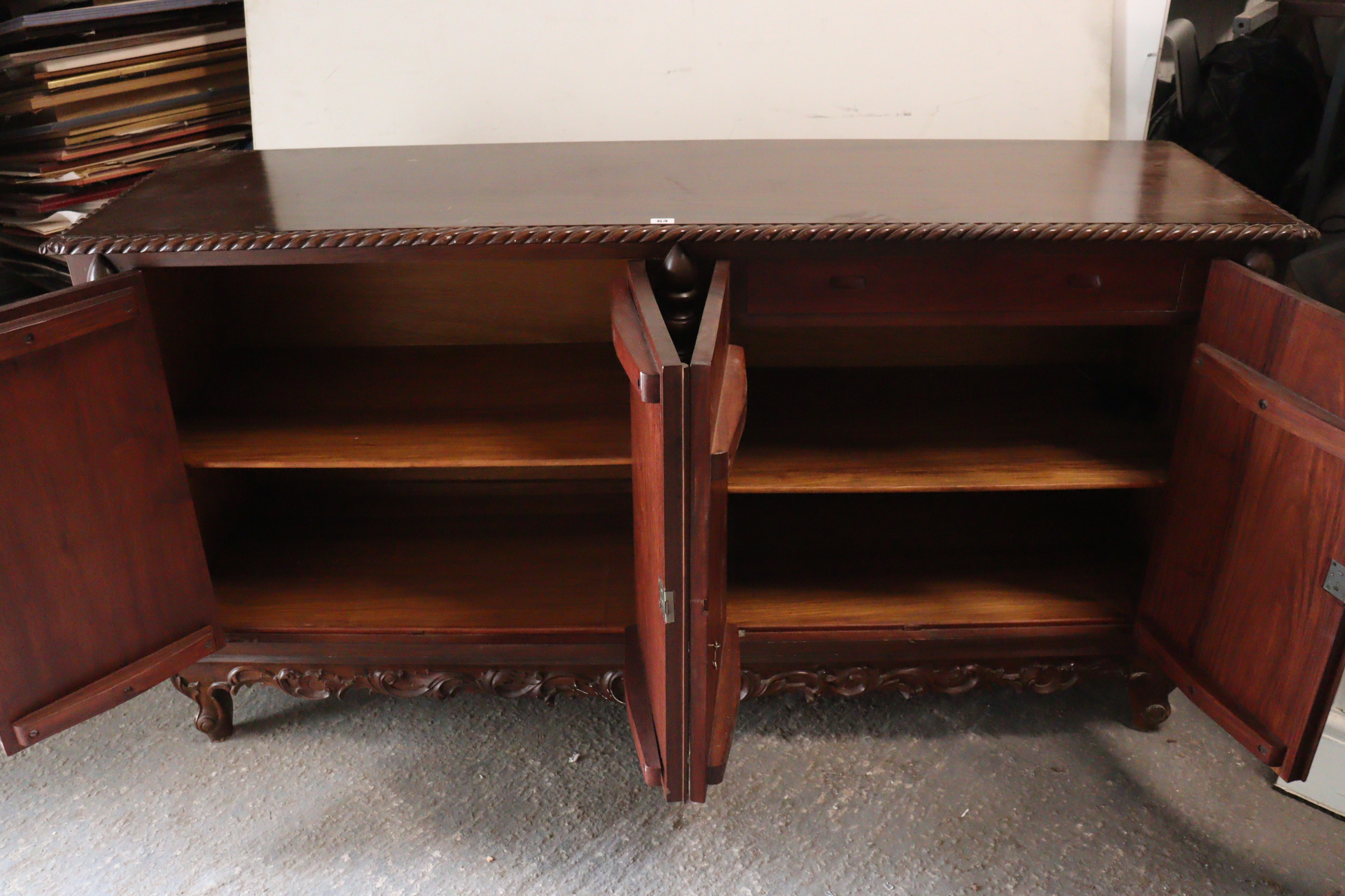 A mahogany sideboard with a gadrooned edge, enclosed by two pairs of carved panel doors, with a - Image 4 of 8