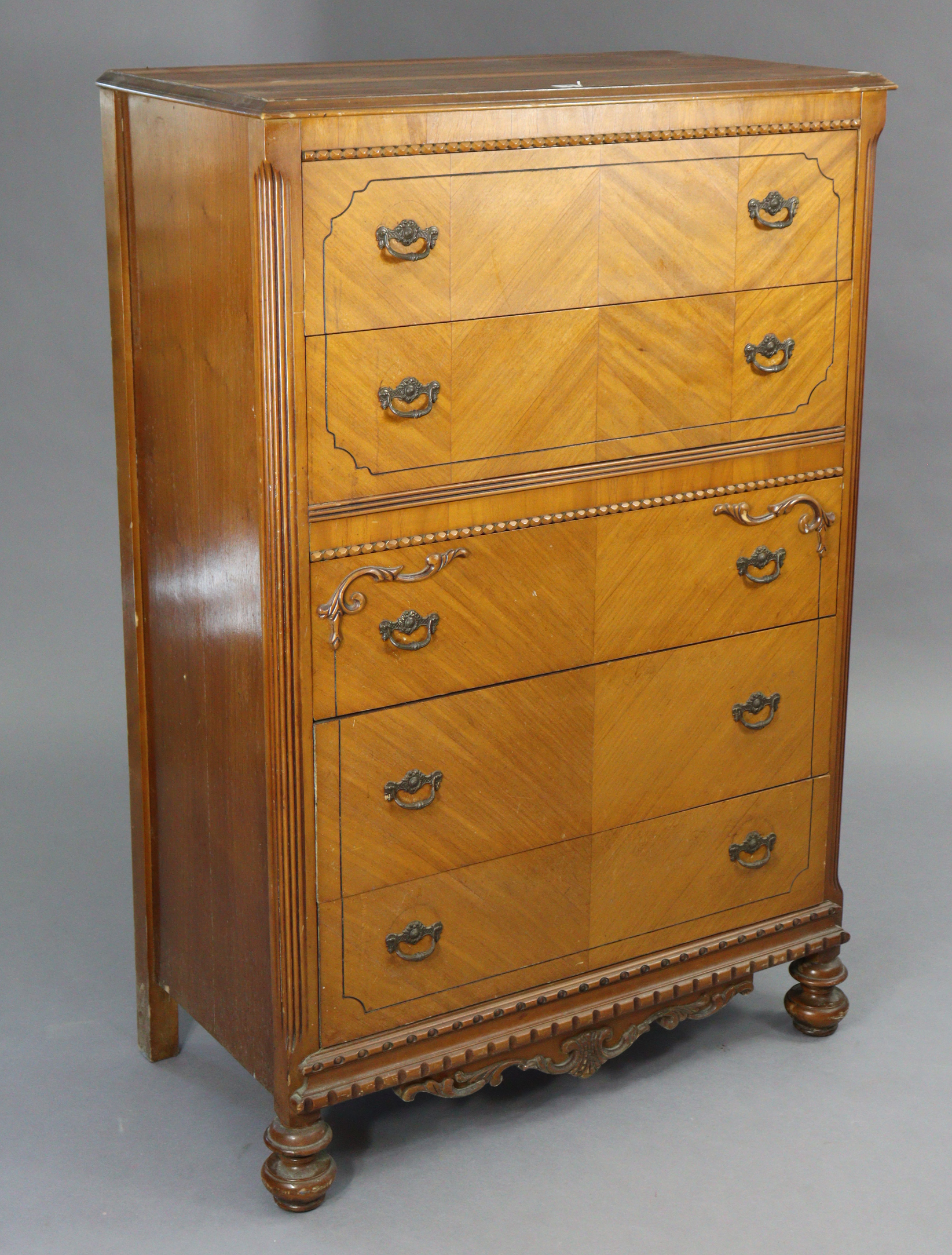 A walnut upright chest fitted five long drawers with iron swing handles, & on turned feet, 34”