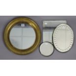 A Victorian circular wall mirror in a brass frame, 15¼” diameter; two small oval sorcerer-type