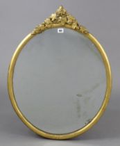 A 19th century gilt frame oval wall mirror with a raised vine-leaf surmount, 29½” x 23”.