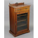 A Victorian walnut dwarf cabinet fitted frieze drawer above three shelves enclosed by a glazed door,