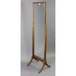 A Guild of Craftsmen mahogany rectangular cheval mirror on square tapered supports & splay legs,