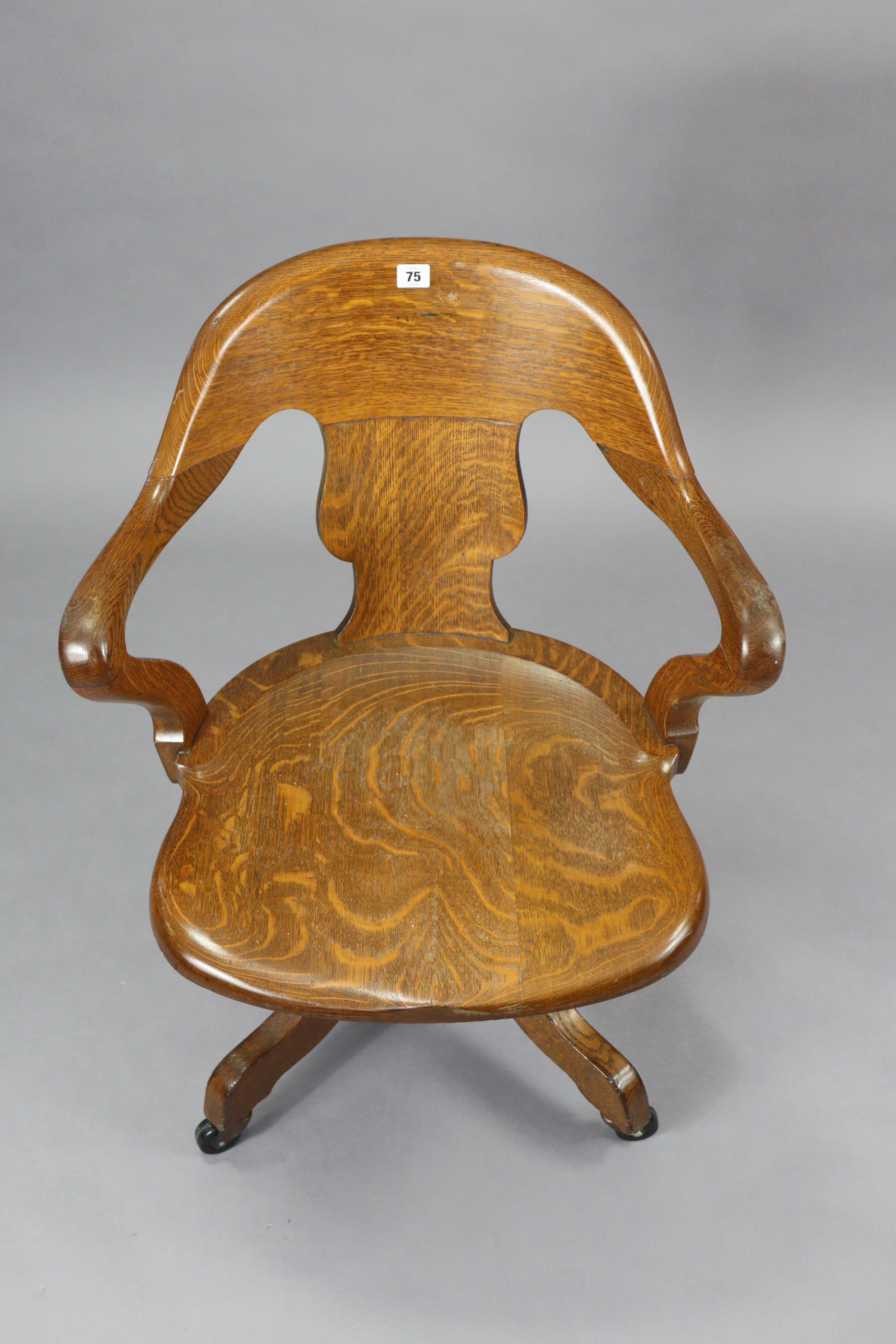 An oak revolving desk chair with a shaped splat back, hard seat & on a sprung base with four splay - Image 3 of 7