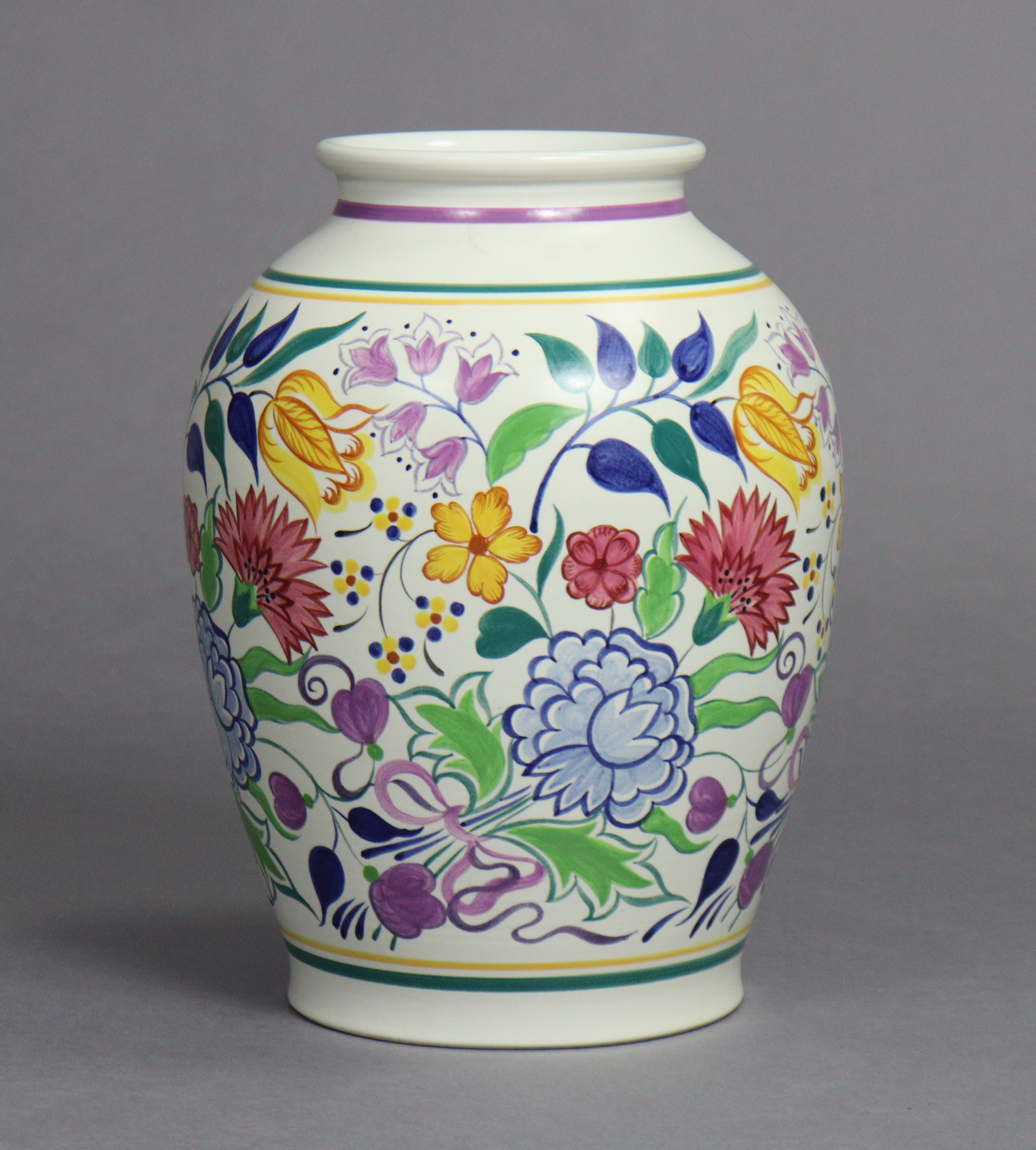 A large Poole Pottery baluster vase painted with flowers in coloured enamels by Gwen Haskins (