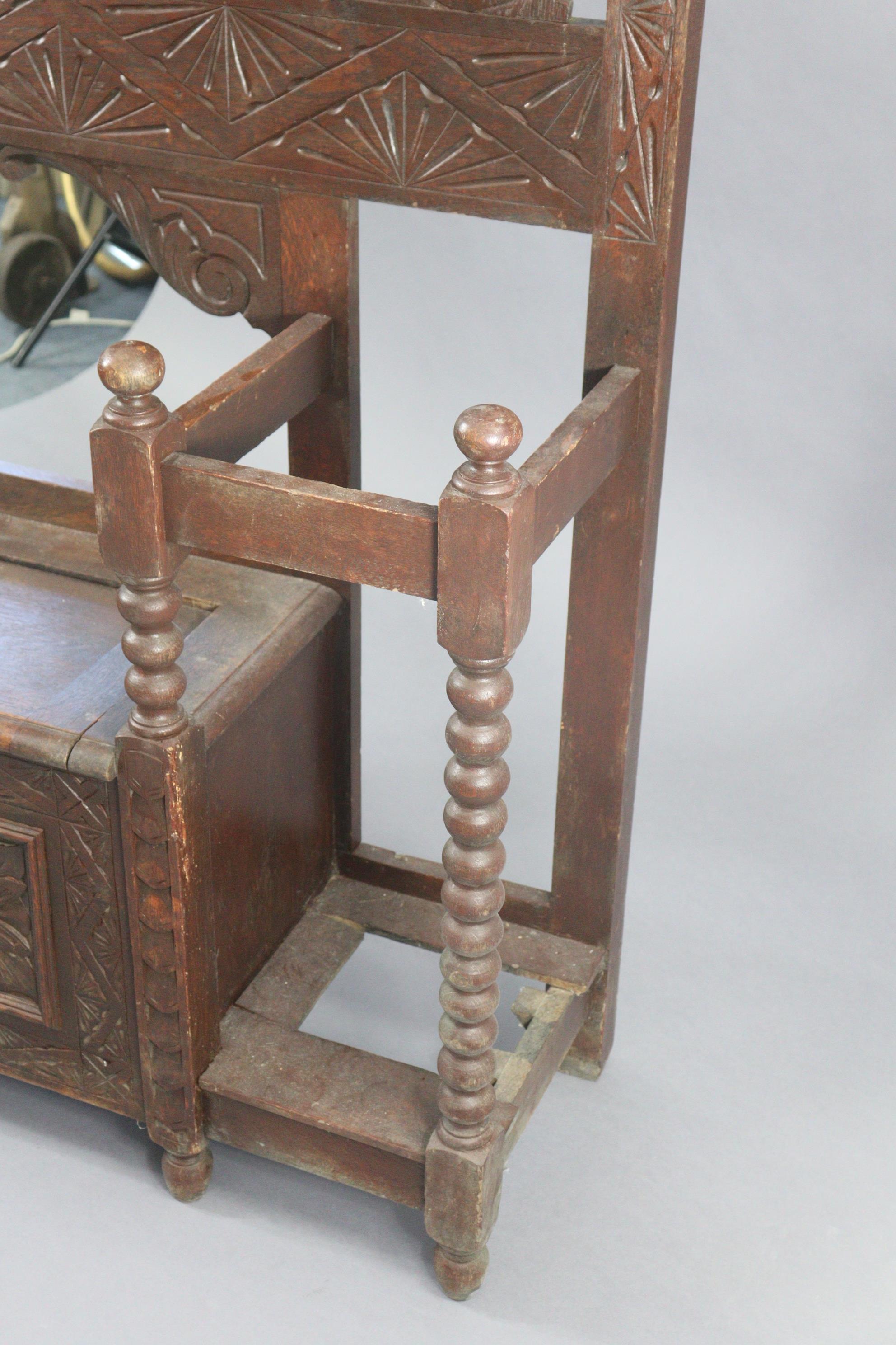 A 1930’s carved oak hall stand inset bevelled rectangular mirror to top, with a hinged box seat & - Image 7 of 7