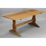 A pine refectory table with a rectangular top, & on shaped end supports joined by a plain centre