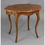 A French-style walnut-inlaid occasional table with a shaped rectangular top, & on four slender